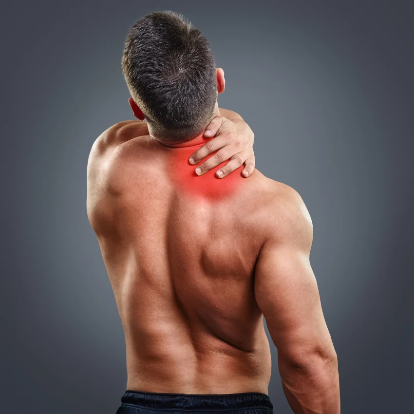 Illustrative photo of a person holding their neck